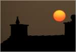 Sonnenuntergang �ber den D�chern von Blonay.